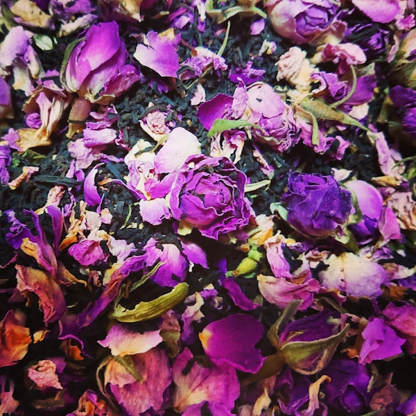 a bunch of purple flowers that are on a table