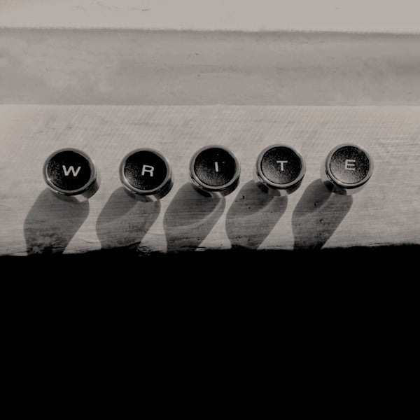 a row of metal knobs sitting on top of a wooden table
