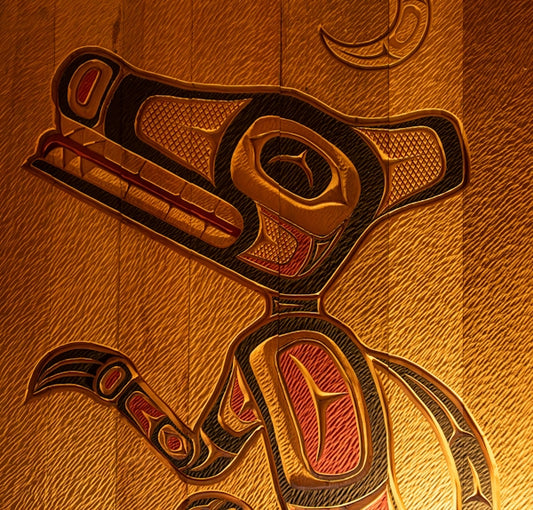 A wood carving of a bird on a wall