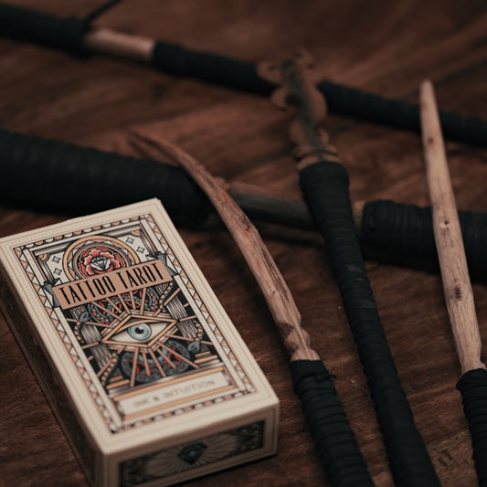 A deck of playing cards next to a box of pens